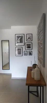 a room with a table and a mirror on a wall at Appartement Standing au coeur d'Albufeira in Albufeira