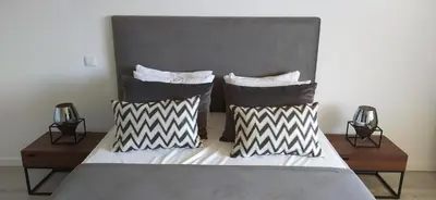 a bedroom with a bed with two pillows at Appartement Standing au coeur d'Albufeira in Albufeira