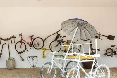 two bikes and an umbrella on a wall at Monte Velho in Loulé