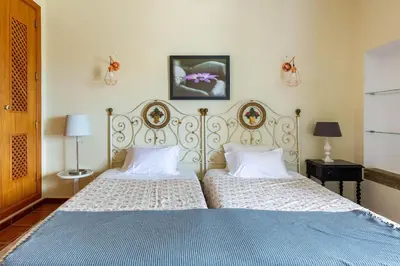 a bedroom with two beds and a blue bed sidx sidx sidx at Monte Velho in Loulé
