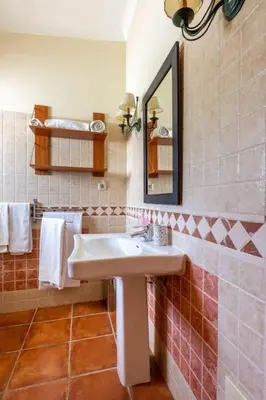 a bathroom with a sink and a mirror and towels at Monte Velho in Loulé