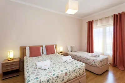 a bedroom with two beds with towels on them at São João das Areias By Albufeira Rental in Albufeira