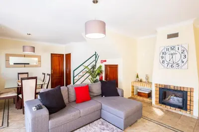 a living room with a couch and a fireplace at Villa Sequeira - Private Pool - Free WIFI - BY BEDZY in Albufeira
