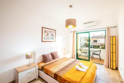 a bedroom with a bed and a balcony at Villa Sequeira - Private Pool - Free WIFI - BY BEDZY in Albufeira