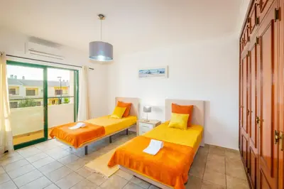 two beds in a room with a window at Villa Sequeira - Private Pool - Free WIFI - BY BEDZY in Albufeira