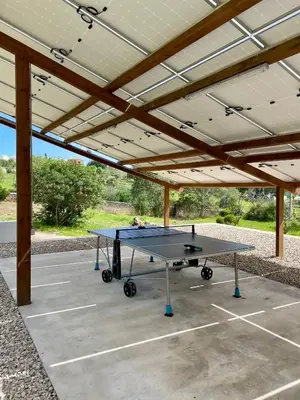 a ping pong table under a pavilion at Einzigartige Landhaus-Villa mit Pool, Sauna, Bar und BBQ in Boliqueime