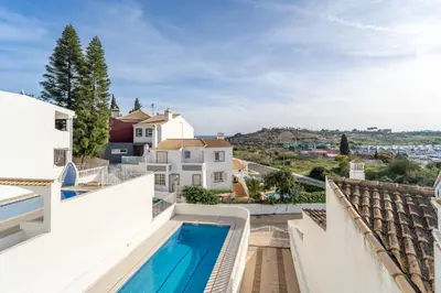 a view from the balcony of a house with a swimming pool at Villa Lemos by HelloVacations in Albufeira