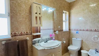 a bathroom with a sink and a toilet and a mirror at Lara Lima by Check-in Portugal in Albufeira