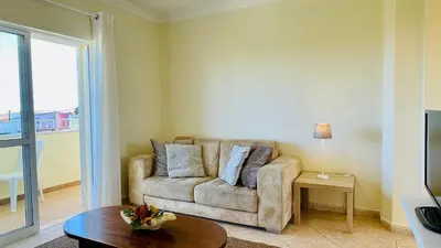 a living room with a couch and a table at Lara Lima by Check-in Portugal in Albufeira