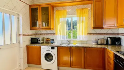 a kitchen with a washing machine and a sink at Lara Lima by Check-in Portugal in Albufeira