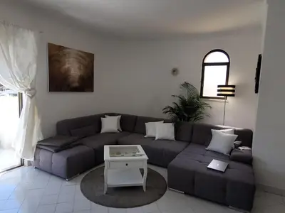 a living room with a television and a table and chairs at Blue Algarve in Albufeira