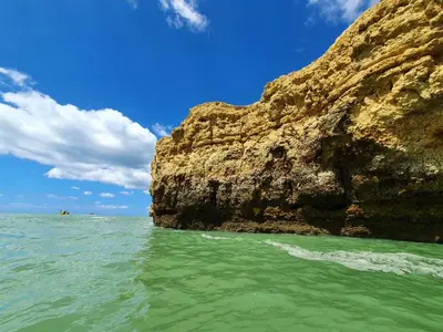a beach with people on the sand and the ocean at Blue Algarve in Albufeira
