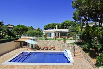 a swimming pool in front of a house at Casa da Horta in Almancil
