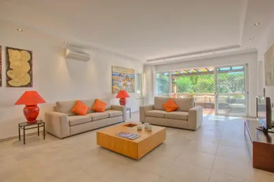 a living room with two couches and a coffee table at Casa da Horta in Almancil