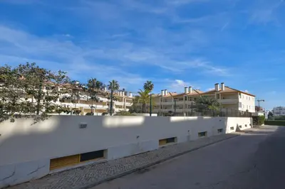 a white wall with a building in the background at Vila Atlântida - Vilamoura-Quarteira Holiday Home - Beach at 250 mts in Quarteira