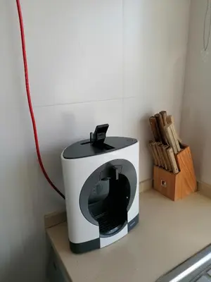 a microwave sitting on a counter with a red cord at Modern apartment with sunny south facing terrace in Albufeira
