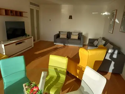 a living room with a couch and a table and chairs at Prestige & Nature Apartment in Laguna Village in Quarteira