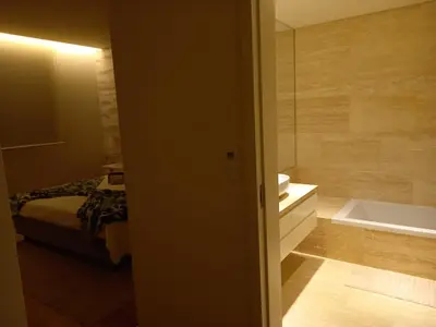 a bedroom with a bed and a bathtub and a bathroom at Prestige & Nature Apartment in Laguna Village in Quarteira