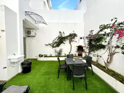 a patio with green grass and a table and chairs at Albufeira Stylish 1 by Homing in Albufeira