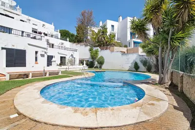 a swimming pool in a yard next to a building at Ocean View Apartment Hakuna Matata in Albufeira