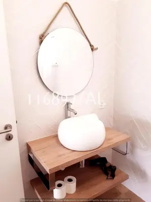 a bathroom with a white sink and a mirror at Beach Apartment Terrace in Vilamoura