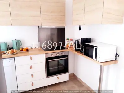 a kitchen with a stove and a microwave at Beach Apartment Terrace in Vilamoura