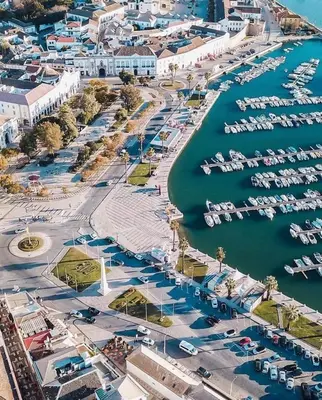 an aerial view of a marina with boats in the water at OmniaX Apartment in Faro