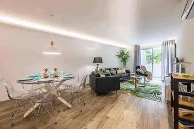 a living room with a table and a couch at Downtown Albufeira 3-Bedroom Luxury Apartment in Albufeira