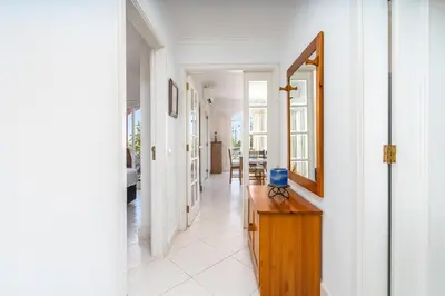 a hallway with a mirror and a wooden table at Vilamoura City Centre Flat in Vilamoura