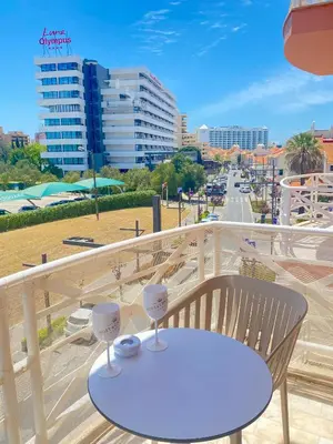 a table on a balcony with a view of a city at Vilamoura City Centre Flat in Vilamoura