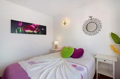 a bedroom with a bed with two pillows on it at Ouramar Apartment in Areias de São João