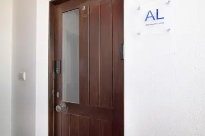 a wooden door in a room with a sign on it at Ouramar Apartment in Areias de São João