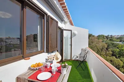 a balcony with a table with fruit on it at Ouramar Apartment in Areias de São João