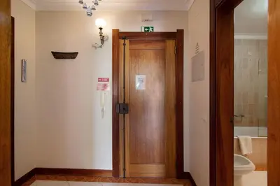 an entrance to a hallway with a wooden door at Paradis Bleu in Albufeira
