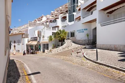 an empty street in front of a building at Paradis Bleu in Albufeira