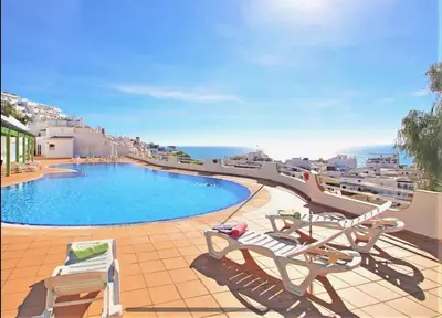 a view of a swimming pool with two lounge chairs at Paradis Bleu in Albufeira