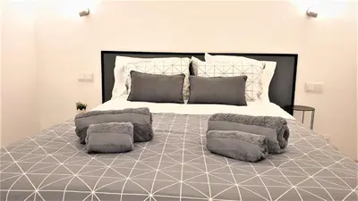 a white living room with a table and chairs at Home Sweet Home in Albufeira