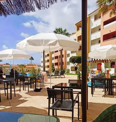 a restaurant with potted plants in front of it at Home Sweet Home in Albufeira