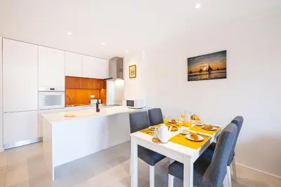 a table with plates of food and glasses of orange juice at #081 T1 Vale Mangude 312 by Home Holidays in Albufeira