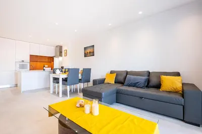 a living room with a couch and a kitchen at #081 T1 Vale Mangude 312 by Home Holidays in Albufeira