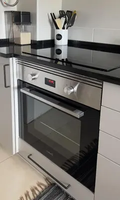 a black and silver oven in a kitchen at Casa AL Reis in Faro
