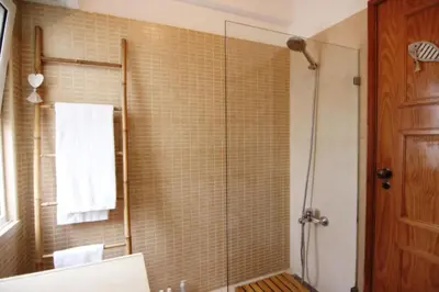a bathroom with a shower with a glass door at Golf Apartment - Solar do Golfe Condominium in Vilamoura