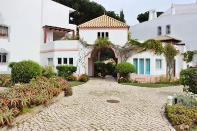 an entrance to a house with a stone driveway at Golf Apartment - Solar do Golfe Condominium in Vilamoura