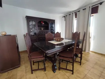 a dining room with a wooden table and chairs at Apartamento V2 Pedro - By Bedzy in Albufeira