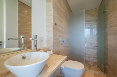 a bathroom with a tub and a toilet and a sink at Apart L'Orange in Vilamoura