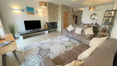 a living room with a couch and a tv at Villa Cascata, 3 bedroom, Pool, close to Olhos de Agua in Albufeira