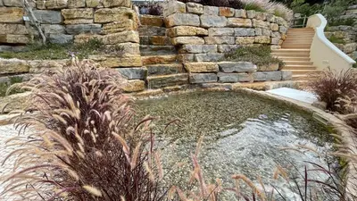 a stone staircase in a garden with plants at Villa Cascata, 3 bedroom, Pool, close to Olhos de Agua in Albufeira