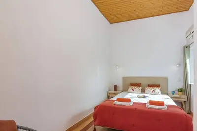 a bedroom with a bed with a red blanket at Villa Casa Calma by Villa Plus in Albufeira