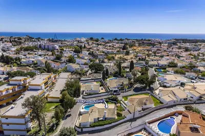an aerial view of a city with houses and the ocean at Villa Pinheiro Oura by Villa Plus in Albufeira