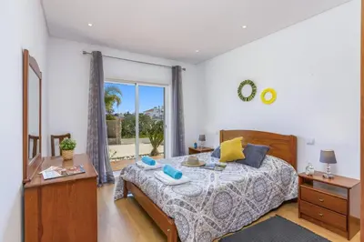 a bedroom with two beds and a window at Villa Quinta dos Abacates by Villa Plus in Olhos de Água